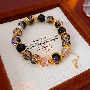 Vintage style beaded crystal bracelet with obsidian and gold-tone hollow sphere spacers