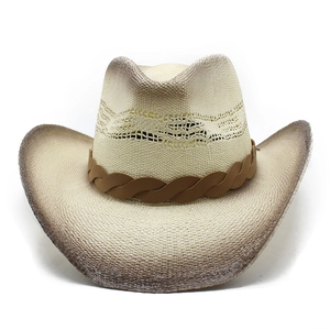 Detail of woven straw cowboy hat with vintage brown gradient brim and leather band