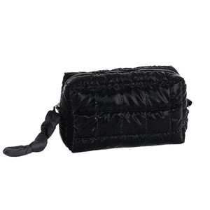 Chic black quilted puffer makeup bag for travel featuring a zip closure and soft fabric