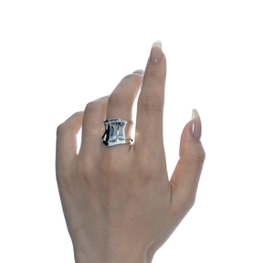 Macro shot of polished silver wavy texture ring showcasing minimalist organic fold design
