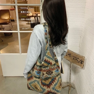 Detailed view of the bohemian plaid plush tote bag texture with vintage geometric patterns
