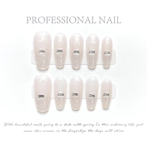 Detailed view of handmade coffin press-on nails with pink gradient and silver rhinestones