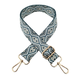 Close-up of geometric diamond pattern woven strap with gold metal hooks and adjustable buckle