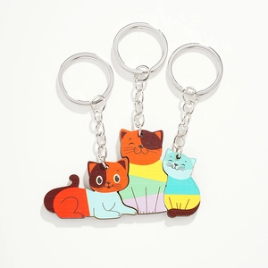 Three cute wooden cat family puzzle keychains for bags with colorful cartoon patterns