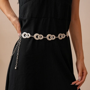 Detail of silver geometric linked waist chain with sparkling rhinestones on black dress