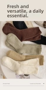 Close-up of soft plush mink velvet socks in earth tones on a cozy white faux fur rug