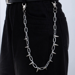 Silver punk trousers chain with metal spikes on black pants shown on a model
