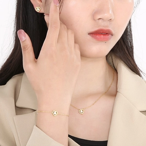 Gold stainless steel jewelry set with hollow heart pendants and cubic zirconia stones