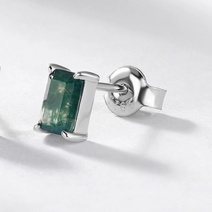 Macro detail of S925 silver earring featuring a green moss agate stone in geometric cut