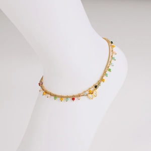 Double-layered golden anklet with butterfly pendant and colorful beads on white background