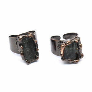 Macro view of adjustable open-ring bands with rectangular dark gemstone inlays