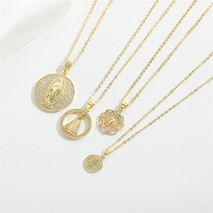 Four religious Virgin Mary gold plated necklaces with zircon pendants on white silk