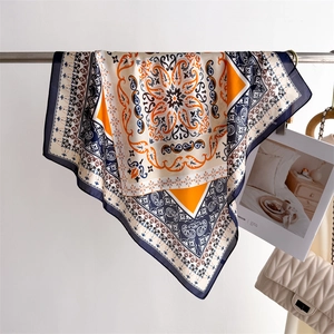 Detail of silk-like square scarf with vintage paisley print and lustrous fabric texture