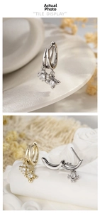 Detail of cross star drop earrings with large cubic zirconia inlay and micro pavé