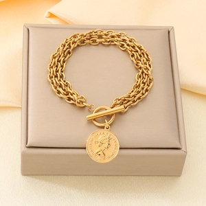 Detail of gold multi-layer chain bracelet with Queen Elizabeth coin pendant and OT clasp