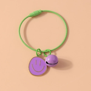 Close-up of green steel wire pet collar with purple smiley face pendant and small bell