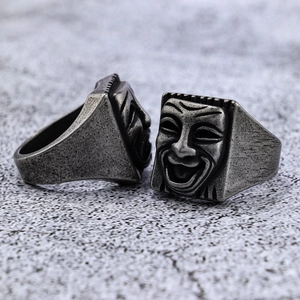 Detailed relief of vintage punk drama mask rings with antique silver finish texture