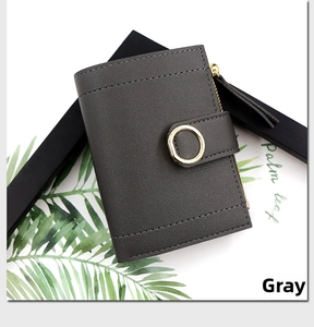 Detail of dark gray short folding wallet with lychee pattern leather and gold round buckle