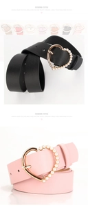 Detail of heart-shaped buckle with pearls on black and pink women's leather belts