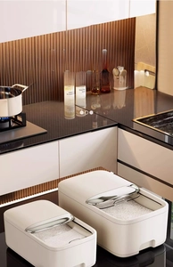 Detail view of large cream cereal storage bin with transparent sliding lid and metal handle