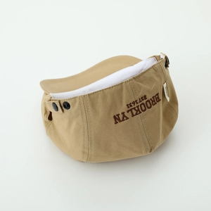 Detail of khaki beret hat featuring BROOKLYN embroidery and premium side snap button
