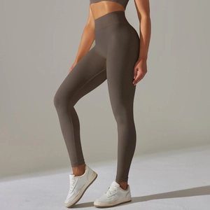 Detail view of seamless high-waist yoga leggings in taupe highlighting push-up shaping effect