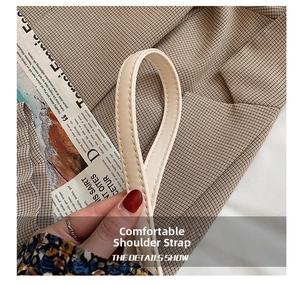 Detail of soft cream leather shoulder strap with fine stitching and chic street style vibes