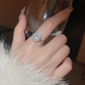 Close-up of spinning snowflake ring with zircon main stone on model's finger