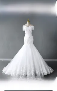 Detail of white mermaid wedding dress featuring off-shoulder lace sleeves and sequins