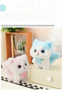 Close-up of plush angel cat keychain with floral decor in pink and blue colors
