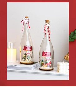 Detail of Christmas snowman and Santa glass bottle lights with LED on wooden base