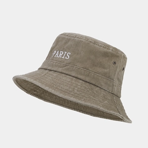 Detailed close-up of PARIS embroidery on vintage olive corduroy bucket hat with metal eyelet