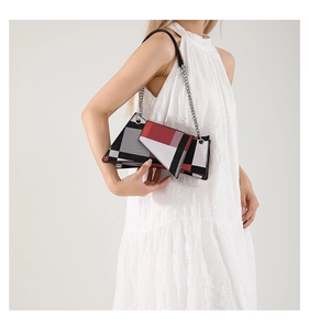 Detail of the geometric patchwork shoulder bag with silver chain and triangle flap