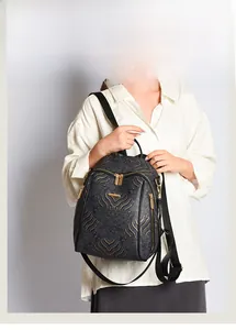 Detail of Chinese style backpack with golden cloud wave patterns and metallic zippers