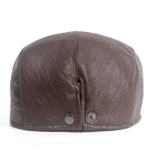 Detail of dark brown leather flat cap with metal buckle and lychee texture