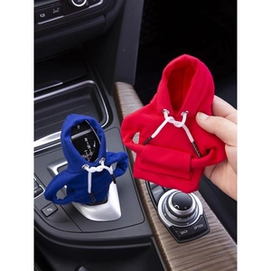 Close-up of mini hoodie car gear shift covers in red and blue knitted fabric