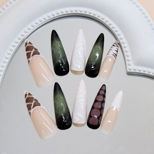 Long stiletto press on nails with brown giraffe print and green cat eye textures