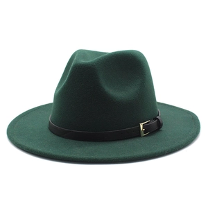 Detail of dark green wool fedora hat featuring a black leather band and gold buckle