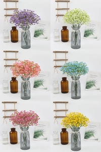 Detail view of multi-colored artificial baby's breath bouquets in grey glass vases