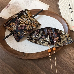 Detail of New Chinese style brocade fabric hair pins with intricate floral embroidery