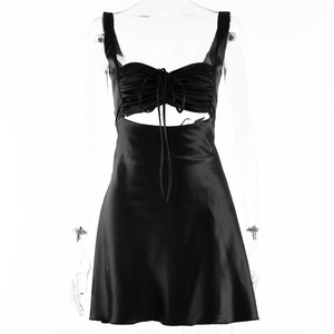 Detail of black satin dress featuring drawstring ruched chest and waist cutout design