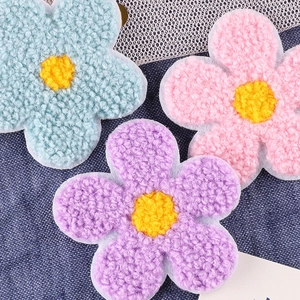 Colorful plush sunflower embroidery patches on blue denim for clothing DIY projects