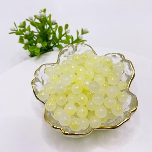 8mm translucent pale yellow glass beads in a gold-rimmed glass bowl for DIY jewelry