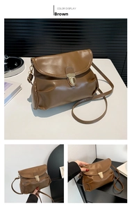 Detail of brown pleated shoulder bag featuring a gold metal buckle and adjustable strap