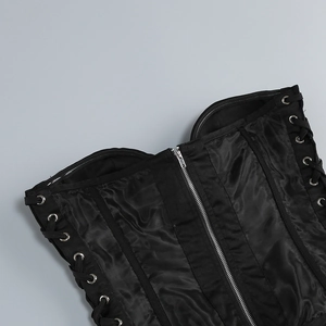 Detail view of black corset top featuring metallic front zipper and side lace-up eyelets