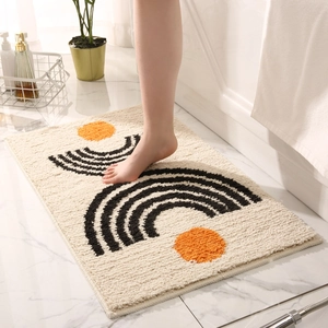 Absorbent bathroom rug with minimalist geometric pattern on beige plush surface