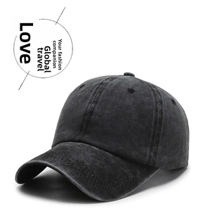 Detailed view of the washed vintage denim texture on a dark grey baseball cap for unisex