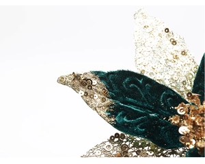 Macro detail of dark green velvet Christmas flower with golden glitter and sequins