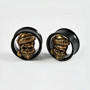 Detail of black double flared ear tunnels with golden Santa Claus skull design inlays