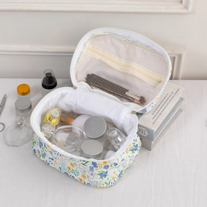 Detailed view of the quilted floral cotton cosmetic bag with internal mesh zipper pocket
